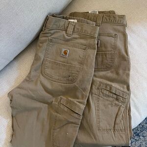 Two pairs of Carrhart relaxed fit pants.